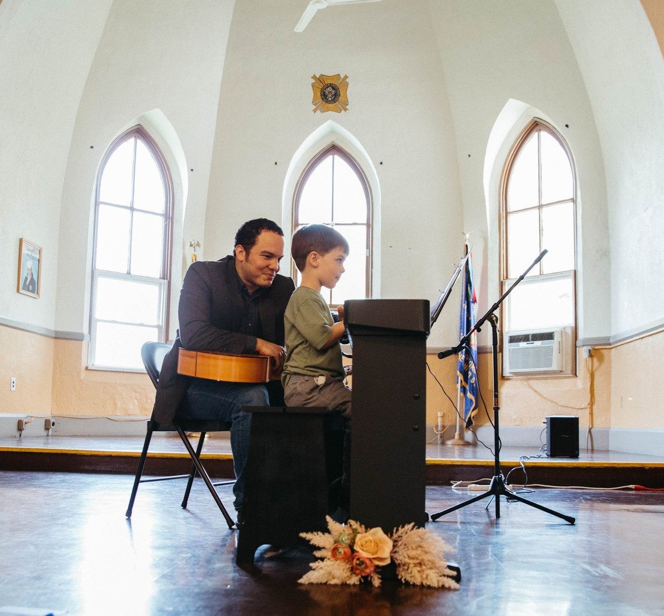 A child at the piano on stage at the music recital